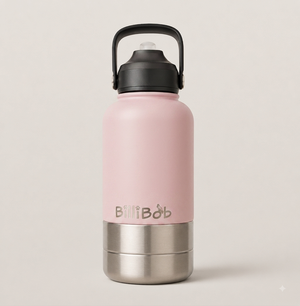 A matte pink insulated water bottle with a black carry loop lid and a brushed stainless steel base, featuring the 'BillBob' logo printed on the front, set against a solid light beige background.